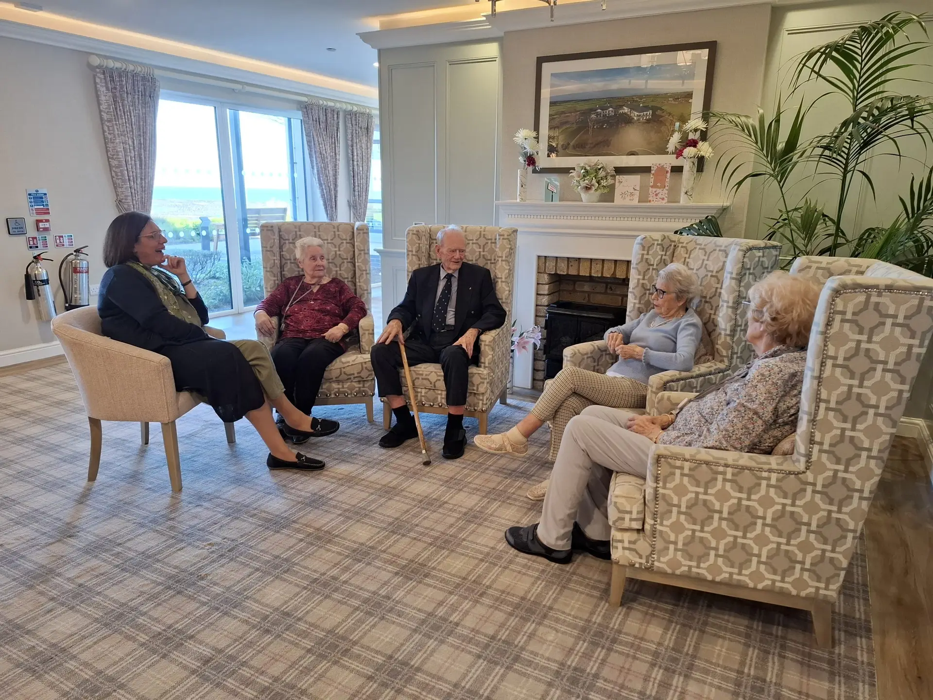 Copelands Chaplain and residents talk seated